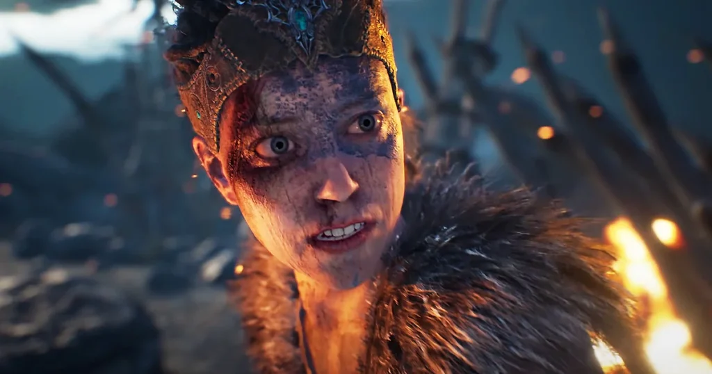 Logo di Ninja Theory accanto a un monitor con un gioco in sviluppo e documenti di ufficio